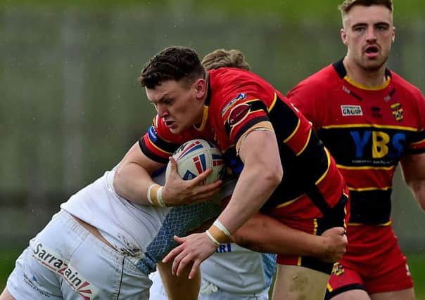 Dewsbury prop Callum Field sees a run halted by the Toulouse defence during last Sundays Betfred Championship clash which saw the French high fliers run out 38-0 winners. Picture: Paul Butterfield