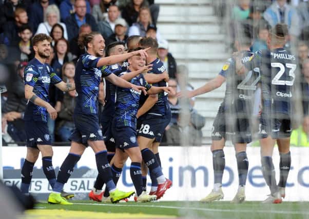 Leeds United players celebrate Kemar Roofe's goal at Derby. Picture: Tony Johnson.