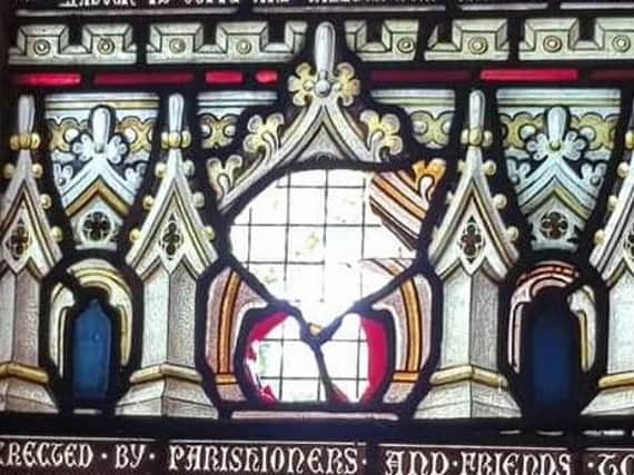 Part of a stained glass window was smashed through by vandals.