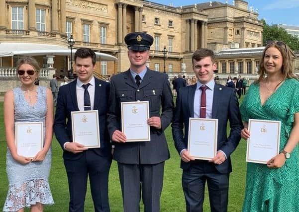 Fab Five: The five members of 868 (Mirfield) Squadron Air Cadets with their certificates at Buckingham Palace. Three other cadets were also invited but could not make it on the day.