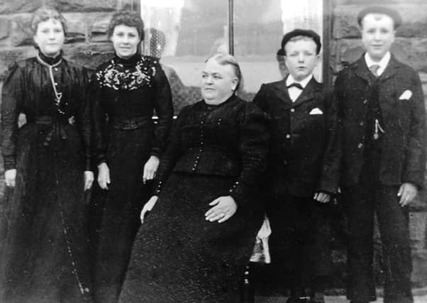 Tragedy: Mrs Harriet Wood, who lost husband William and two sons John and Friend in the disaster. She is pictured some years later with her four remaining children. She had to send another son, Harry, pictured next to her, down the pit when he was only 12. Her other children were Mary Ellen, pictured far left, and Emma and Gladstone.