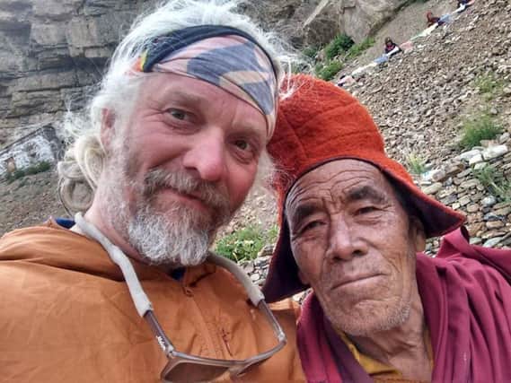 Darren Clarkson-King in Bhutan. Below: Meeting the locals on his travels.