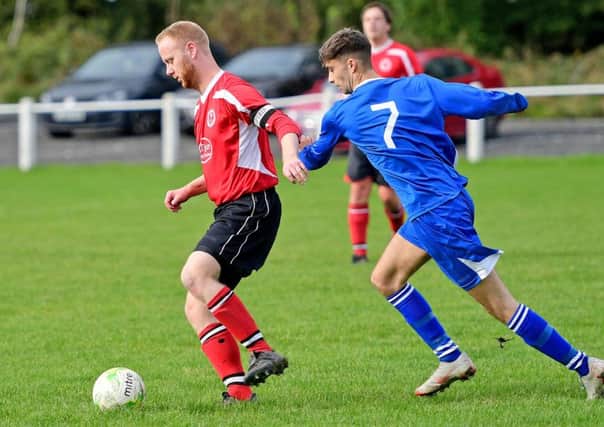 An Altofts player shields the ball from Hunsworths Simon Coy duirng last Saturdays West Yorkshire League encounter.