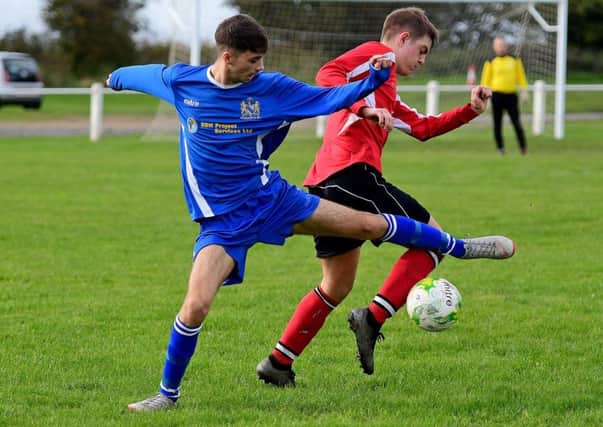 Hunsworth's Simon Coy and Jack Wombwell, of Altofts, battle for possession during last Saturdays West Yorkshire League Division Two clash. Pictures: Paul Butterfield