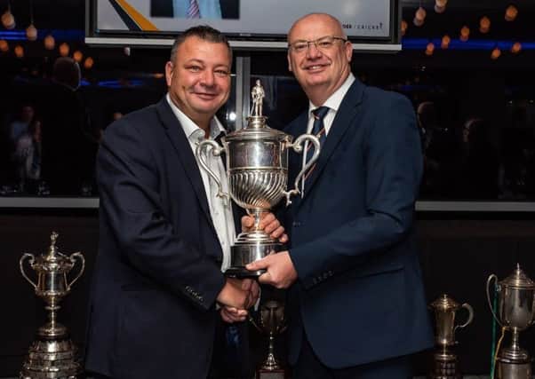 Birstall's Mark Gilman receives the Bradford Premier League Unsong Hero Award from chairman David Young.
