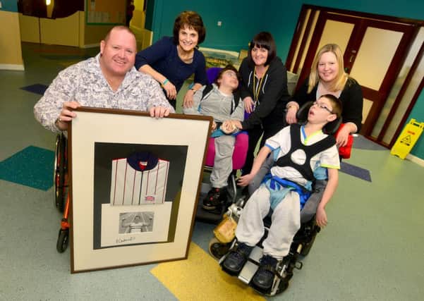 Former Paralympian Paul Cartwright donating his tracksuit from the 1984 Games to Hollybank Trust. Pictured with Pam King, Hazel Haywood, Alisa Moore, Daisy Booth and Alex Clement. (D534A305)