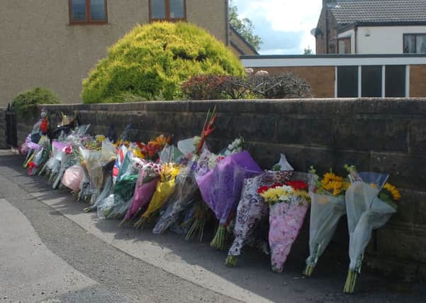 TRIBUTE: Flowers were left at the scene where Josh Hirst was stabbed near Hepworth Lane, Mirfield. (d543h232)