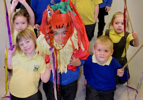 Pupils at Shaw Cross Infant and Nursery School taking part in a performance dressed as a chinese dragon. (d621a307)