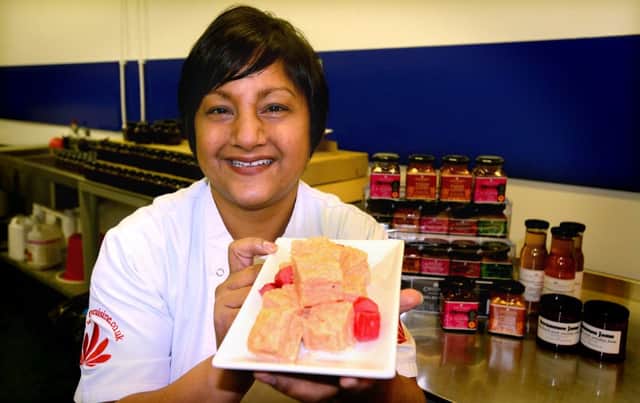 Prett Tejura from Curry Cuisine with some of the products using locally grown rhubarb in their chutneys and jams. (d630b307)