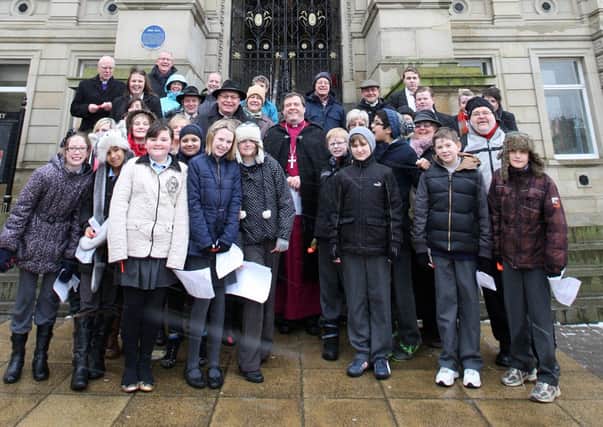 Children joining church leaders of different faiths on the steps outside the town hall praying to strengthen communities. Bishop of Pontefract