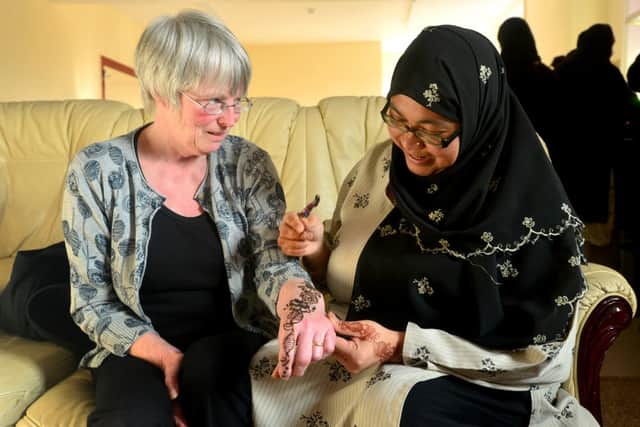 HENNA ART Judy Kirkby watches Naznin Nasimulgani apply the henna. (D517D308)