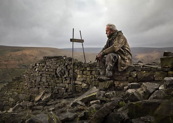 REFLECTIVE MOOD Andy Snaith has snapped members of the West Yorkshire Dry Stone Walling Association. Bill Wilson is pictured.
