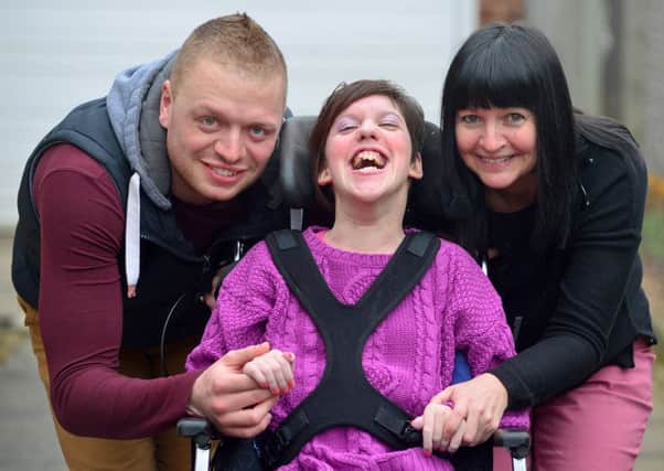 MAKING A WISH: Mary Hinde, who suffers from cerebral palsy, needs to raise £16,000 for a new wheelchair with help from her mum, Sarah, and personal assistant Sean Milnes. (D536A310)