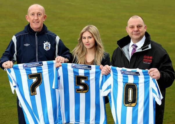 Huddersfield Town's Mark Lillis and Robyn Deegan with Paul Gowland of the Yortkshire Air Ambulance.