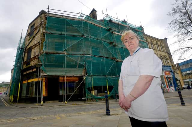 Gillian Roberts (owner of Dewsbury Diner) is concerned that scaffolding on a building next to her shop is making Daisy Hill look derelict and affecting business in the area. (D536B317)