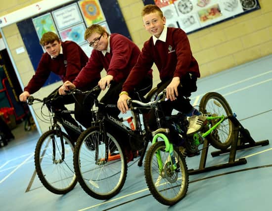 Static bikeathon held at Ravensthorpe school.
Macoley Ratcliffe (front) with fellow pupils Brandon Bastow and Philip Pickering.
d315a319