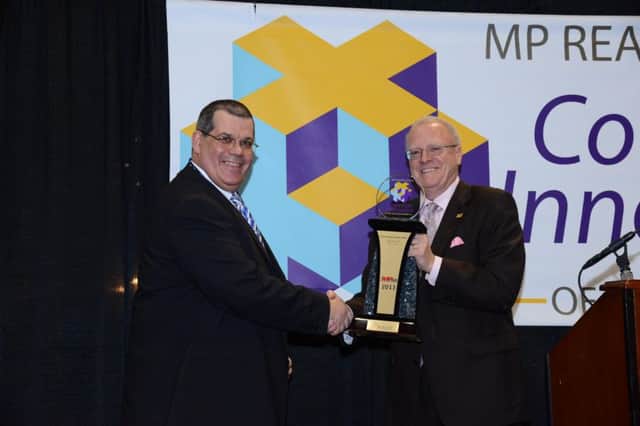 Flexitallic's Russ Currie is presented with the award by NACE pressident Kevin Garrity.