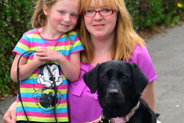 Samantha Heaton is a new guide dog owner. She is supporting a campaigning by Guide Dogs for the Blind to encourage people to think about guide dog users when parking on pavements and cluttering shopping areas with A boards and seating. Samantha with her guide dog Tango and her daughter Daisy. (D534A319)