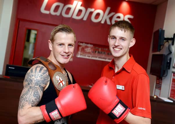 BOXING CLEVER English super-featherweight champion Gary Sykes with store manager Chris Singleton. (d305a324)