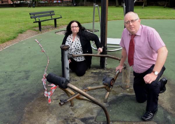 FIRE DAMAGE Councillors Paul Kane and Cathy Scott with burnt-out equipment at Earlsheaton Park. (d625a327)