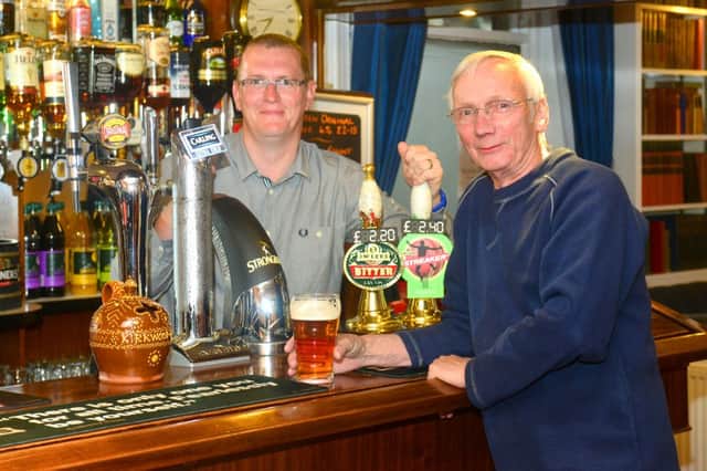 Mirfield Knowl Club is celebrating its 125th anniversary this weekend - the main event being a beer festival. Bar manager Paul Moon with 10 year member Barry Tingle. (D535C327)