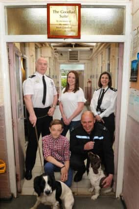 Superintendent Pat Casserly, Ben Goodlad, Helen Goodlad, Sergeant Rick Green and Inspector Lorna Meredith with two Police Dogs at the opening of the  Goodlad Suite.