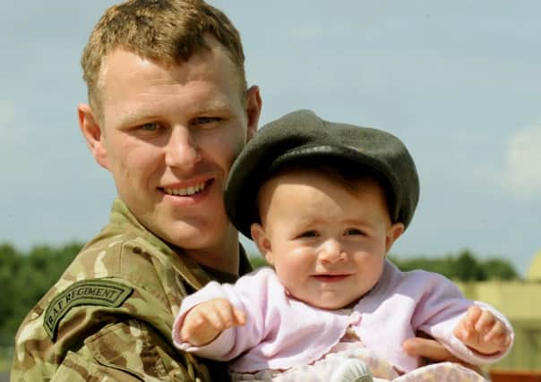040713   Senior Aircraftman Liam Brooke from Dewsbury back with his 10 month old daughter Tarlia-Fayth Brooke at the homecoming parade of 34 Squadron at Raf Leeming who have returned from Afghanistan.