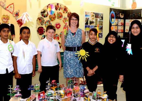 BUDDING ARTISTS BGHS teacher Leanne Hainsworth with pupils from Batley Girls and Field Lane School. (d614a329)