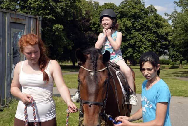 DEWSBURY REPORTER
The Trojan club is Thornhill, Dewsbury, held a Summer's Fayre in memory of Summer Rogers Ratcliffe. Enjoying her short ride on 'Bobby' is Scarlett Cole, 7.
Leading the way are, left: Mia Davies and Francesca Bayraktar.
 
picture mike cowling july 6th 2013