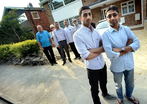 Calls for speeding restrictions to be put in after a speeding car crashed into wall on Boothroyd Lane. His house is near to two schools and Crow Next Park but people regularly exceed 80mph.  Picture shows Fayyaz Patel (front L) with his father, Yusuf. d302a331