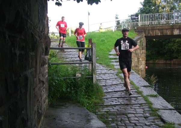 Runners taking part in the first Flat Cap Five on the canal tow path. Dewsbury road runners event.
