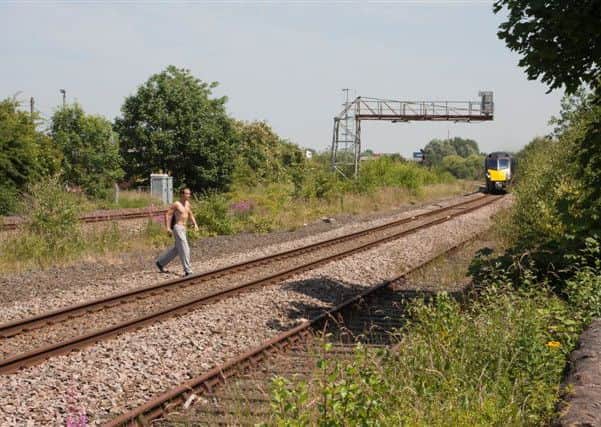 British Transport Police would like to identify this man after he was caught on camera trespassing on the tracks near Horbury signal box in Wakefield at around 1.15pm on Tuesday July 9.