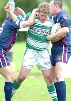 Amateur Rugby League. Dewsbury Celtic v. Warrington Wizards. Celtics James Eatherley gets caught up by the Wizards. (26050967)