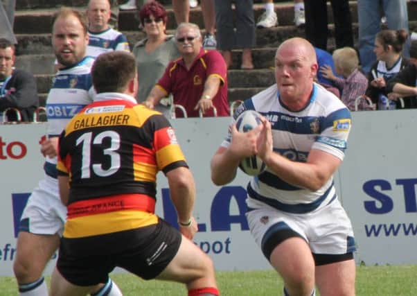 Featherstone prop Steve Crossley finds his way blocked by Dewsbury's Tommy Gallagher in Sunday's Kingstone Press Championship game. Picture: Bob Nunn.