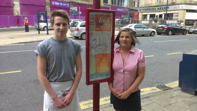Deborah Restall and her son Jack at a bus stop outside their shop, Igloo.