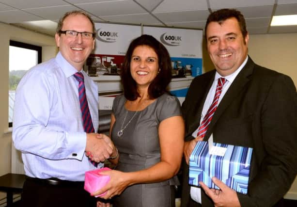 Howard Bamforth and Michelle Ledgard receiving long service award from Nigel Rogers at 600 Group. (d601a338)