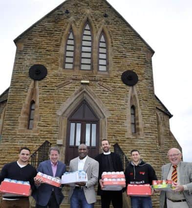 Champion boxer Evander Holyfield visited Shaw Cross Community Church to meet One Community trustee Chris Battye (far right) to see what he can do to lend his support to its work in Kirklees,he brought with him a van load of food stock.From left,Kane Bentley of Dewsbury Rams,Yank Barry,Chairman and Co-founder of Global Village Champions Foundation,Evander Holyfield,The Reverend Tom Hiney,Curate for Team Parish Dewsbury,Brad Watkinson of Dewsbury Rams.