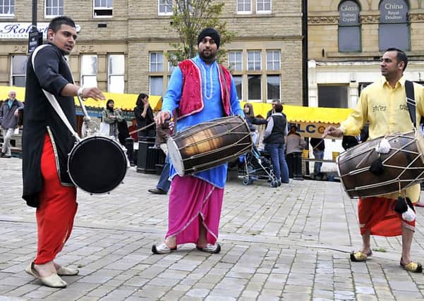 Dhol drummers entertain visitors in the Market Place at Batley Festival, left to right,Jaytan Singh,Jas Bhogal,Bups Flora.