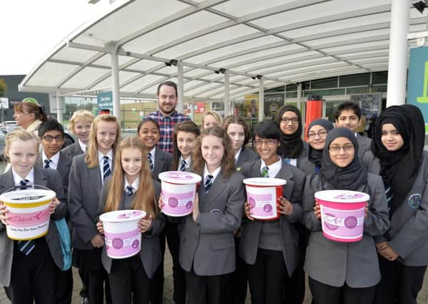 Students from Thornhill Comunity Academy, appearing on television's Educating Yorkshire, packed customers goods at ASDA in Dewsbury on Saturday to raise money for charity. Students are pictured with Mr. Matt Burton, assistant head teacher.picture mike cowling oct 19 2013