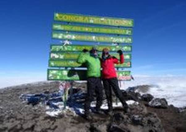 HIGH POINT Andy and Katie Wallwork at the summit of Kilimanjaro.