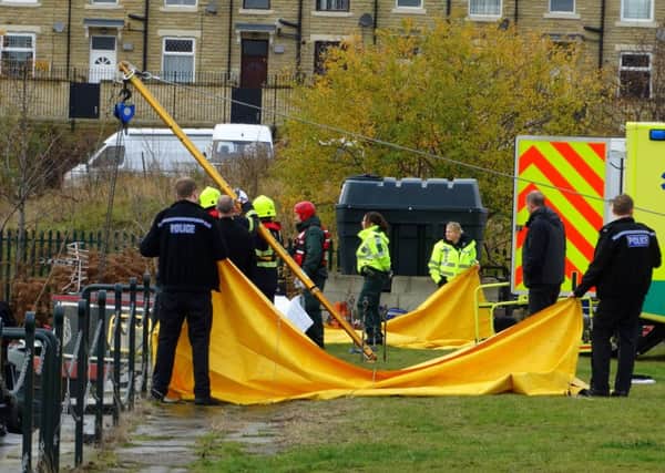 POLICE INVESTIGATION Emergency services at Savile Town Wharf where the man's body was found in the water.