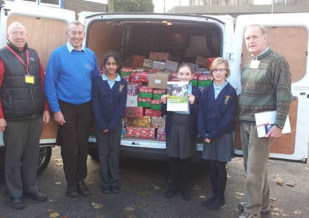 St Joesph's School and Parish  Operation Christmas Child collection. Grace McNulty, Annie Storey and Maariya Hussain receive the certificate of special thanks from Samaritan's Purse representatives Martin Warriner and his team.