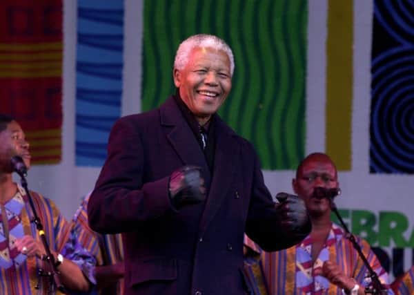 Nelson Mandela dances on stage while visiting Millennium Square in 2001.
