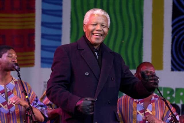 Nelson Mandela dances on stage while visiting Millennium Sqaure on Monday 30th April 2001.