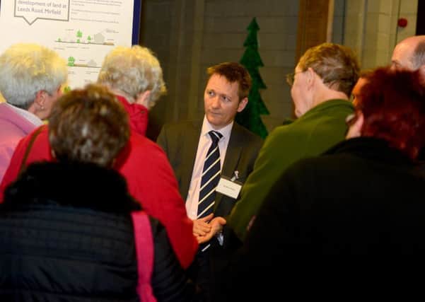 TOUGH QUESTIONS Andrew Paley from Taylor Wimpey is probed about the proposals by residents. (D511A350)