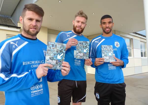 Huddersfield Town players Oliver Norwood, Adam Clayton and Oscar Gobern  with the 2014/5 Kirklees College full time prospectus.