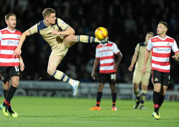 Goal scorer Matt Smith controls a high ball during Leeds United's game at Doncaster Rovers.