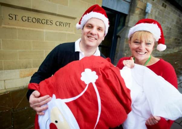 COZY CHRISTMAS John Cotton business manager Gary Johnson and St George's Crypt lead fundraiser Cheryl Harrington.