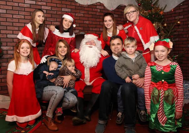 Santa's Grotto at Mirfield Fire Station. With Father Christmas and his helpers are Hannah Pearson, Tim Hope and Theo, Stevie and Dexter Pearson-Hope