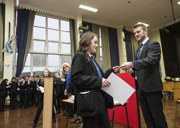 AWARDS CEREMONY Ambassador Madison Laverick collects her training certificate from assistant principal Andy Cox.